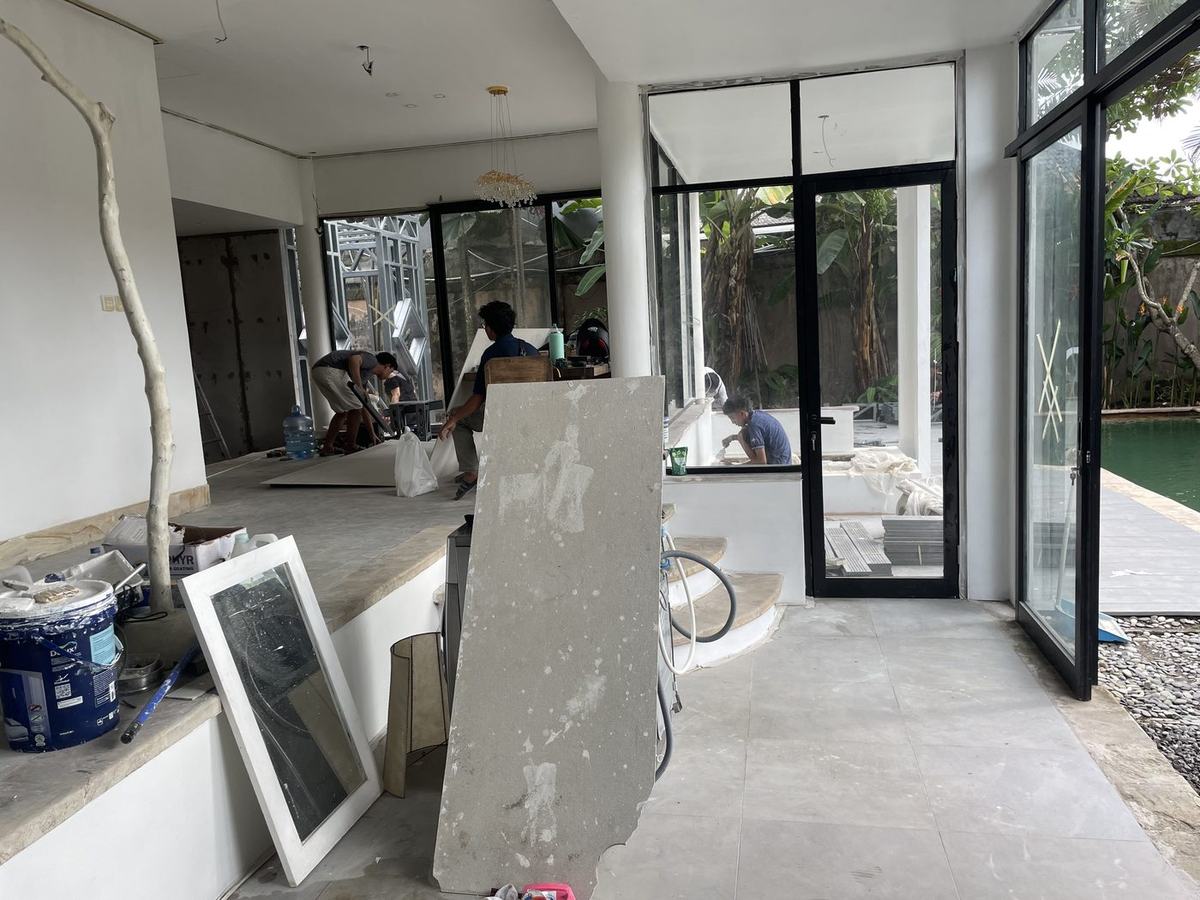 Villa interior fit-out stage with glass doors and pool, Bali