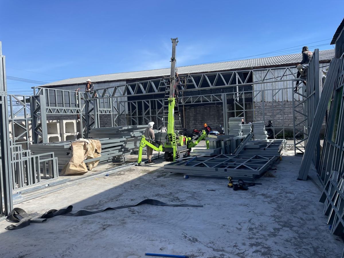 ILO crew standing prefabricated LGS wall panels with spider crane